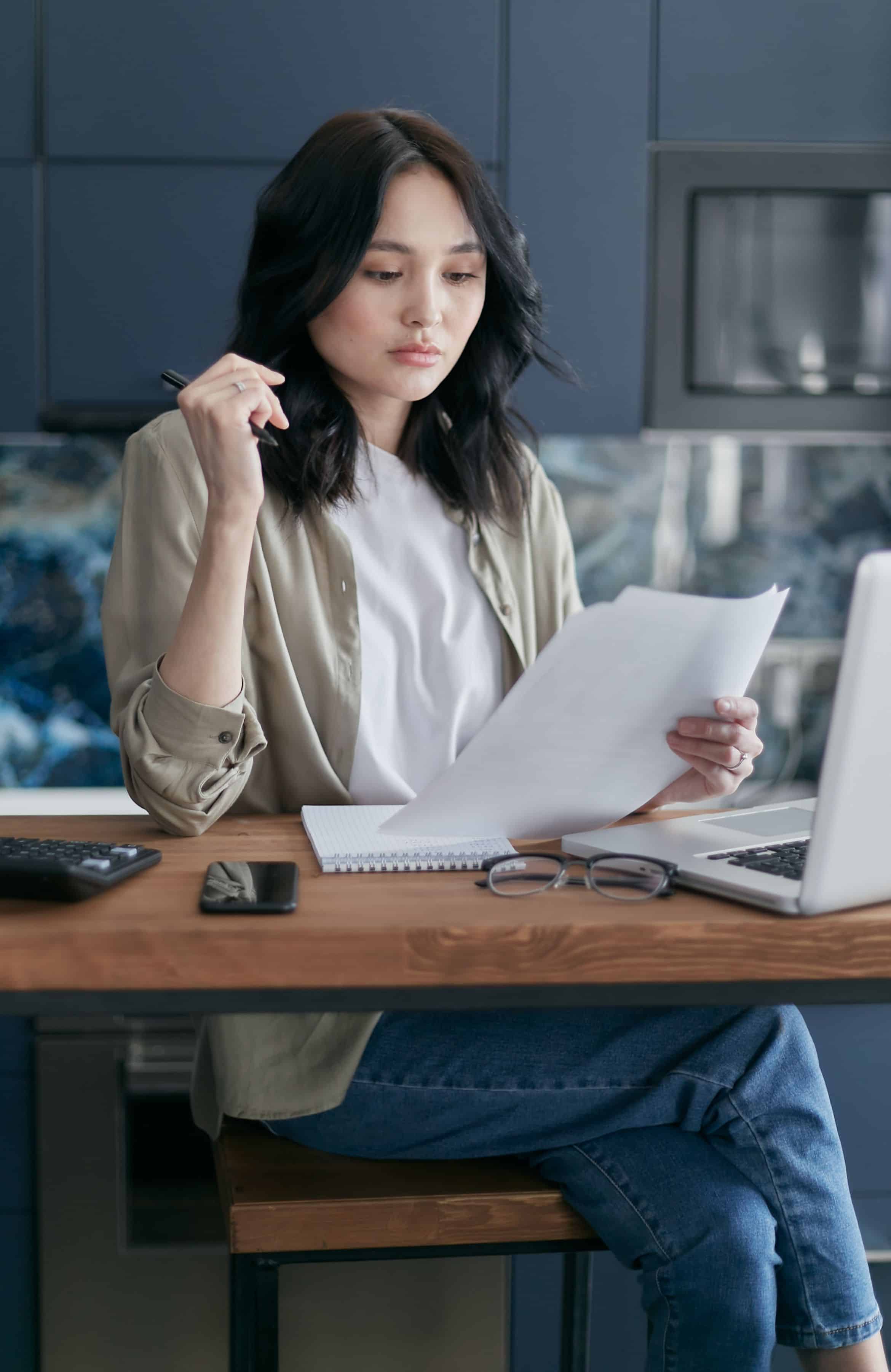 Staff member reviewing billing at a laptop