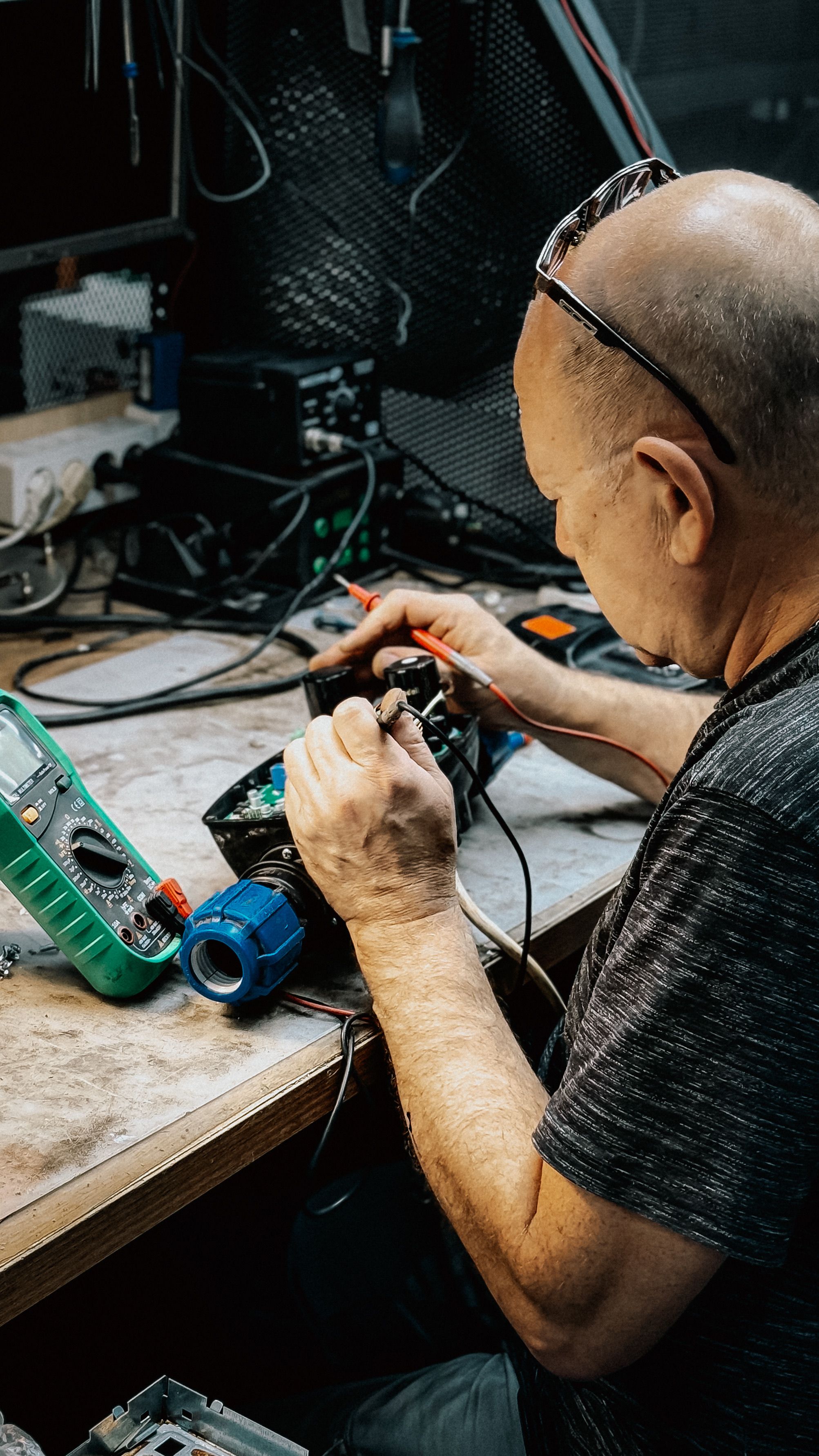 Technician repairing equipment on a workbench